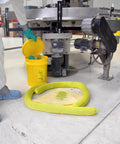 Worker using Hazmat Spill Kit in Reusable Bucket with 10 Yellow Pads, 3 Absorbent Socks, Nitrile Gloves, and Safety Goggles in industrial setting.