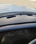 Installed ECOTRIC dash bezel cover for Dodge Ram, black plastic with vent slots above instrument cluster.