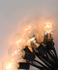 Old School Edison G40 Replacement Light Bulbs 5W Clear Globe 1.5 Inch Dimmable Bulbs Fits E12 Candelabra Base glowing in dark