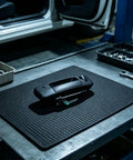 RDHFTNIHU Access Latch Component on a workshop surface, matte black finish, designed for 2007-2013 pickup tailgate use.