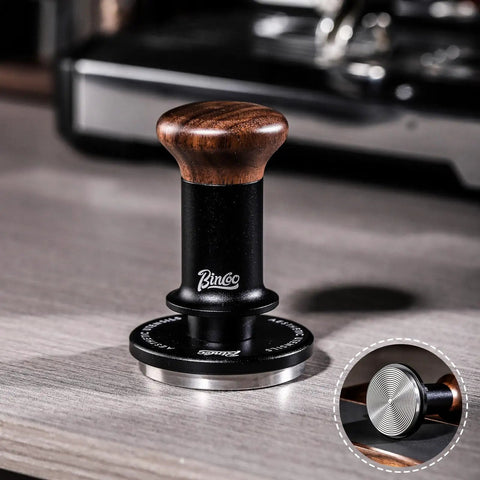 58mm Espresso Tamper With Ripple Base And Spring Loaded Precision Pressure For Even Extraction on countertop, walnut handle visible.