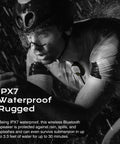 Cyclist wearing a Wearable Bluetooth V5.3 Clip-On Speaker With 30 Hour Battery Life, IPX7 Waterproof, ENC Mic For Hands Free Calls in rain.