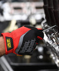 Person using FastFit Work Gloves With Precision Fit For Dexterity And A Grip On Point Anti Slip And Abrasion Resistant Heavy Duty Touchscreen Compatible Vibration Damping Multipurpose Use Size Large Color Red while working on machinery.