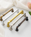 Variety of metal cabinet pulls with different finishes on display, including oil rubbed bronze. Kitchen and drawer hardware collection.
