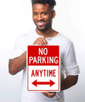 Heavy Duty No Parking Anytime Warning Sign With Bright Arrows held by a man, showing aluminum construction and visibility.