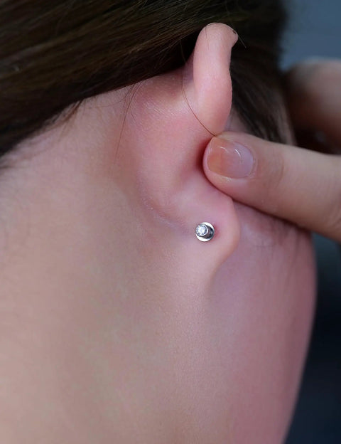 Solid Implant Grade Titanium Screw Back Earrings Made For Sensitive Skin With Hypoallergenic F136 Studs That Stay Put And Keep Your Jewelry Low Drama Always, worn in ear with a white opal stone.