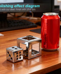 Dice-shaped and cube-shaped polished steel objects with a red can for size reference on a wooden desk.