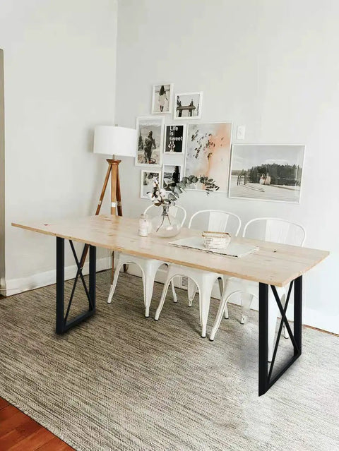 Industrial Triangle Table Legs 28 Inch Set Of 2 Cast Iron Welded Black Desks Nightstands Coffee Tables Diy Ready With Four Adjustable Pads Heavy Duty Wrought Iron Legs For Modern Farmhouse And Industrial Furniture supporting a wooden tabletop in a modern dining setting.