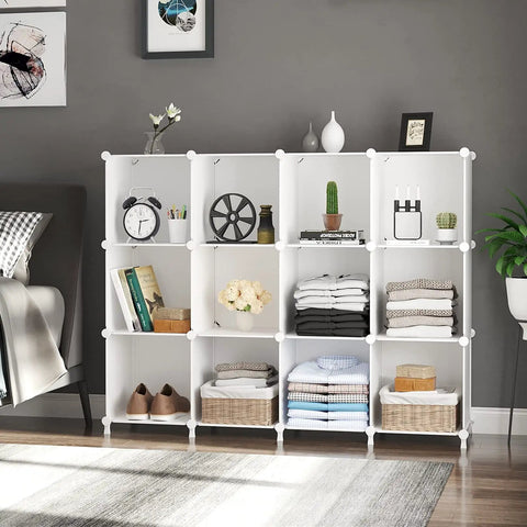 Cube Storage Organizer 12 Cube Bookshelf DIY Plastic Closet Clothes Shelves With Wooden Mallet Stackable Storage Solution For Home Bedroom White Great For Home Organization And Kids Rooms, showing organized items including books and towels in a living room.