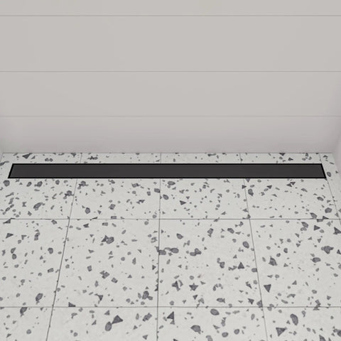 Modern Linear Shower Drain Built Tough With Premium 304 Stainless Steel And A Slick Matte Black Finish installed on terrazzo flooring.