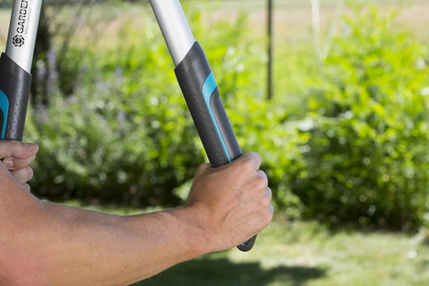 Close-up of hands holding Heavy-Duty Tree Loppers With Steel Blade And 35.5 Inch Handle, Telescoping TeleCut 650-900 B Pruner.