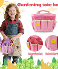 Smiling child holding Pink Kids Gardening Tools Set With Rake Shovel Trowel Watering Can Gloves Apron Tote Bag Plant Pots And DIY Bookmark Kits For Toddlers And Kids Kid Friendly Outdoor Garden Play Gift, with embroidery tote bag detail.