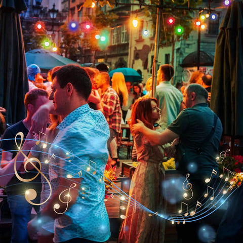 People dancing under colorful Outdoor String Lights For Patio And Backyard 48 Feet RGBW LED Bulb Set at a lively evening event.