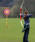 Archer aiming at target on Adjustable Foldable Metal Tripod Archery Target Stand For Backyard And Shooting Range Bow And Arrow