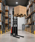 Heavy Duty Straddle Stacker Handles 3,300 Lbs With Semi Electric Lift for Tight Spaces, elevating pallet loads in a warehouse.
