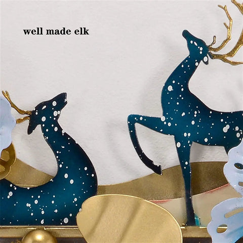Two decorative elk figures made of metal with a snowy design, suitable for festive wall decor.