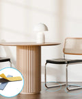 Eight Piece Premium High Density Self Adhesive PTFE Rectangle Furniture Glides under black chair on wood floor.