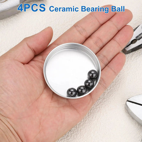Top Tier Four Piece 10mm Silicon Nitride Ceramic Bearing Balls G10 Precision Grade displayed in a hand and container.