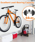 Orange bicycle mounted on a garage wall next to a lawnmower with weight capacity text "66lbs" and an image of dumbbells.