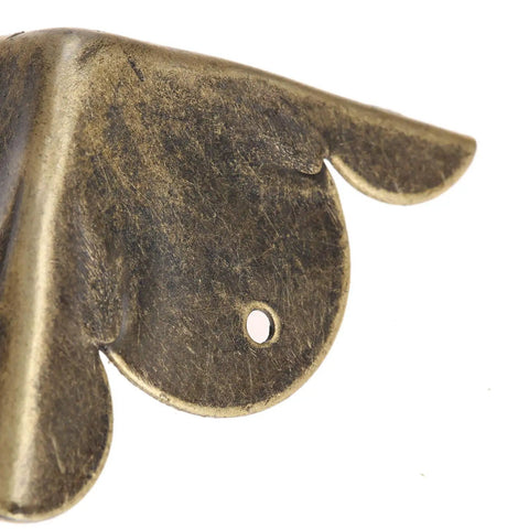 Solid Antique Bronze Corner Protectors, 12 Piece Heavy Duty Furniture Edge Guards detailed view of a corner bracket with a screw hole.