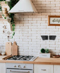 Wall Mounted Pot Lid Organizer Rack For Lids And Cutting Boards ABS Black in kitchen on brick wall near cutting boards