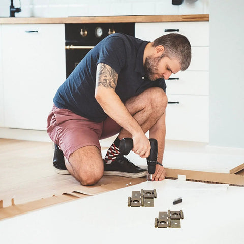 Person installing cabinets with 10 Pieces Double Acting Iron Door Hinges For Wine And Display Cabinets, retro style hardware visible