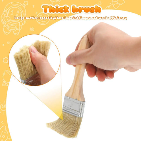 Hand holding thick wooden handle 2 inch flat paint brush, part of 30 Piece Thick Wooden Handle 2 Inch Flat Paint Brush Set For Walls And Wood Stain Multipurpose DIY Home Improvement Tools For Fence Deck And Furniture Finishing Do It All