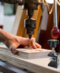 Set Of 4 Heavy Duty C Clamps For Woodworking And Metalworking shown in use on a wooden board under a drill, rust resistant black aluminum alloy.