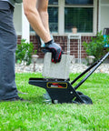 Man using 20 Inch Premium Push Spike Aerator with 3D Galvanized Steel Tines and weight tray on lawn for core penetration