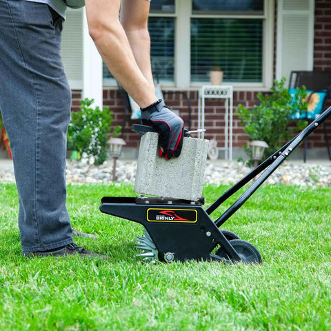 Man using 20 Inch Premium Push Spike Aerator with 3D Galvanized Steel Tines and weight tray on lawn for core penetration