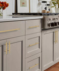 Champagne Bronze Cabinet Pulls 10 Pack 5 Inch Center To Center Knurled Kitchen Cabinet Handles installed on beige cabinetry