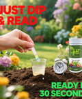 Hand using Ultimate Soil pH Tester Strips Kit 3 To 9 Range With 100 Strips in garden with flowers and timer showing 30 seconds.