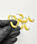 Gloved hand holding a soft yellow worm from Rugged Rubber Maggots Bait Set For Freshwater Fishing With 12 Hooks And 12 Worms Crappie