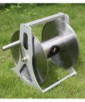 Heavy Duty Stainless Steel Garden Hose Reel Wall Mount Holder With Rolling Cart on grass, showcasing durable design for outdoor use.