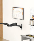Sleek Wall Mounted Keyboard Tray 26 Inch Heavy Duty Steel Platform With Dedicated Mouse Nook Raised Edge Guard Adjustable Tilt Angle Black installed on wall.