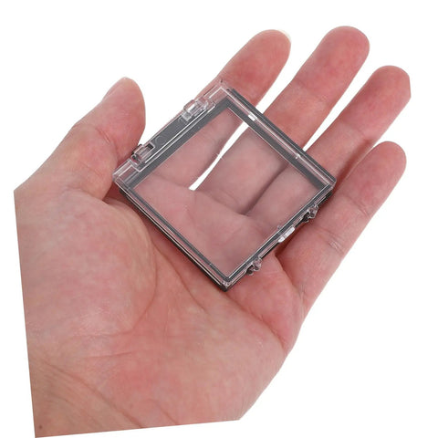 Hand holding transparent Push Button Safety Cover 2 Pack Sturdy Plastic Protection Cap for computer, dishwasher, washing machine