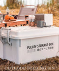 Heavy Duty Rolling Bin With Secure Lid And Easy Roll Casters, Stackable Outdoor Camp Organizer on grass by snacks and drinks.