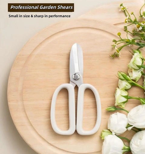 Ultra Sharp Garden Shears For Plants And Bonsai Pruning Stainless Steel With Anti Slip Serrations Effortless Cutting Through Half Inch Branches Clean Smooth Cuts For Floral Arranging And Garden Care On The Go on a wooden board next to white flowers