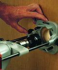 Person using DIY Friendly Portable Precision Drill Guide For 3/8 And 1/2 Inch Drills With Built In Protractor on wooden surface.