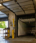 Heavy Duty Cantilever Dock Gate 12 Foot Wide Double Action Slick Pneumatic Struts, installed in a warehouse loading bay.