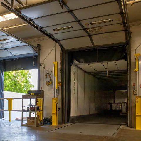 Heavy Duty Cantilever Dock Gate 12 Foot Wide Double Action Slick Pneumatic Struts, installed in a warehouse loading bay.