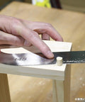 Using Top Tier Japanese Flush Cutting Hand Saw For Fine Woodworking on a wooden dowel for precise trimming.