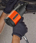 Heavy Duty 1/2 Inch Drive Pneumatic Impact Wrench delivers 1100 foot pounds torque, held by gloved hands for auto repair.