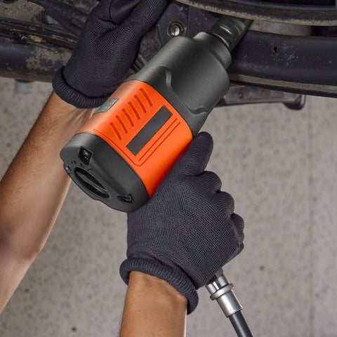 Heavy Duty 1/2 Inch Drive Pneumatic Impact Wrench delivers 1100 foot pounds torque, held by gloved hands for auto repair.