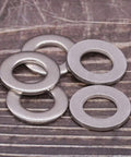 1/4-inch stainless steel flat washers, bright finish; four pieces shown, ID 0.28 in, OD 0.63 in.