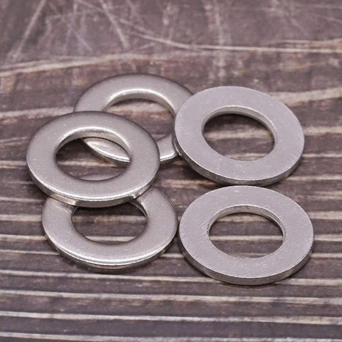 1/4-inch stainless steel flat washers, bright finish; four pieces shown, ID 0.28 in, OD 0.63 in.