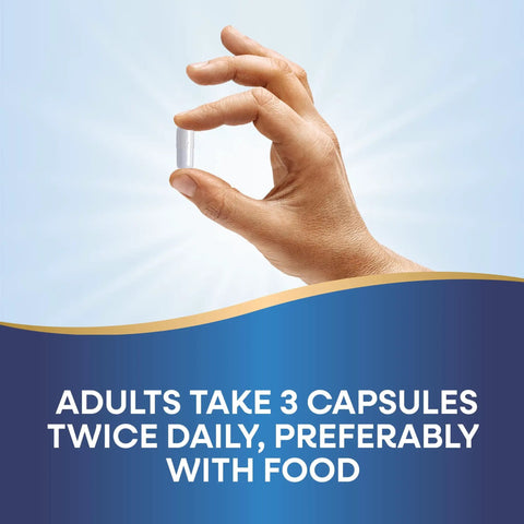 Hand holding a single capsule from Calcium And Magnesium Mineral Complex For Strong Bones And Muscle Support, 750 Mg Per Three Capsule Serving.