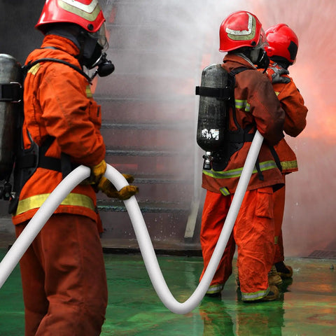 Firefighters using Heavy Duty Lay Flat Fire Hose 1.5 Inch By 100 Feet White Backwash And Discharge Hose With Brass NPSH NPT Connectors.