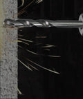 Close-up of a carbide tipped pilot drill bit from the 10 Piece Quarter Inch Pilot Drill Bit Set for Hole Saw Arbor drilling into masonry.