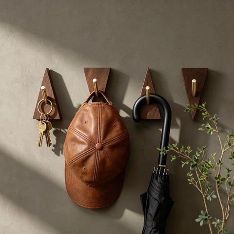 Solid Black Walnut Triangle Wall Hooks With Brushed Brass Caps, Heavy Duty Entryway Coat Rack, Hella Sturdy Key Holder That Keeps Your Living Space Totally Sick And Super Organized, displaying a cap and keys.